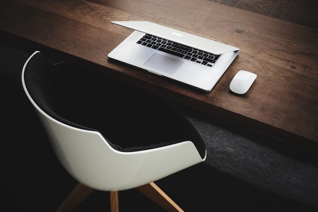 Exploring The Benefits Of Ergonomic Chair Desk Glides 1 Apple MacBook beside computer mouse on table
